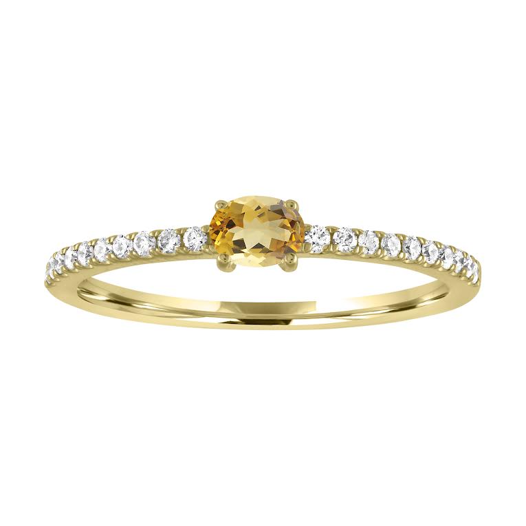 Yellow gold skinny band with an oval citrine in the center and round diamonds along the shank.
