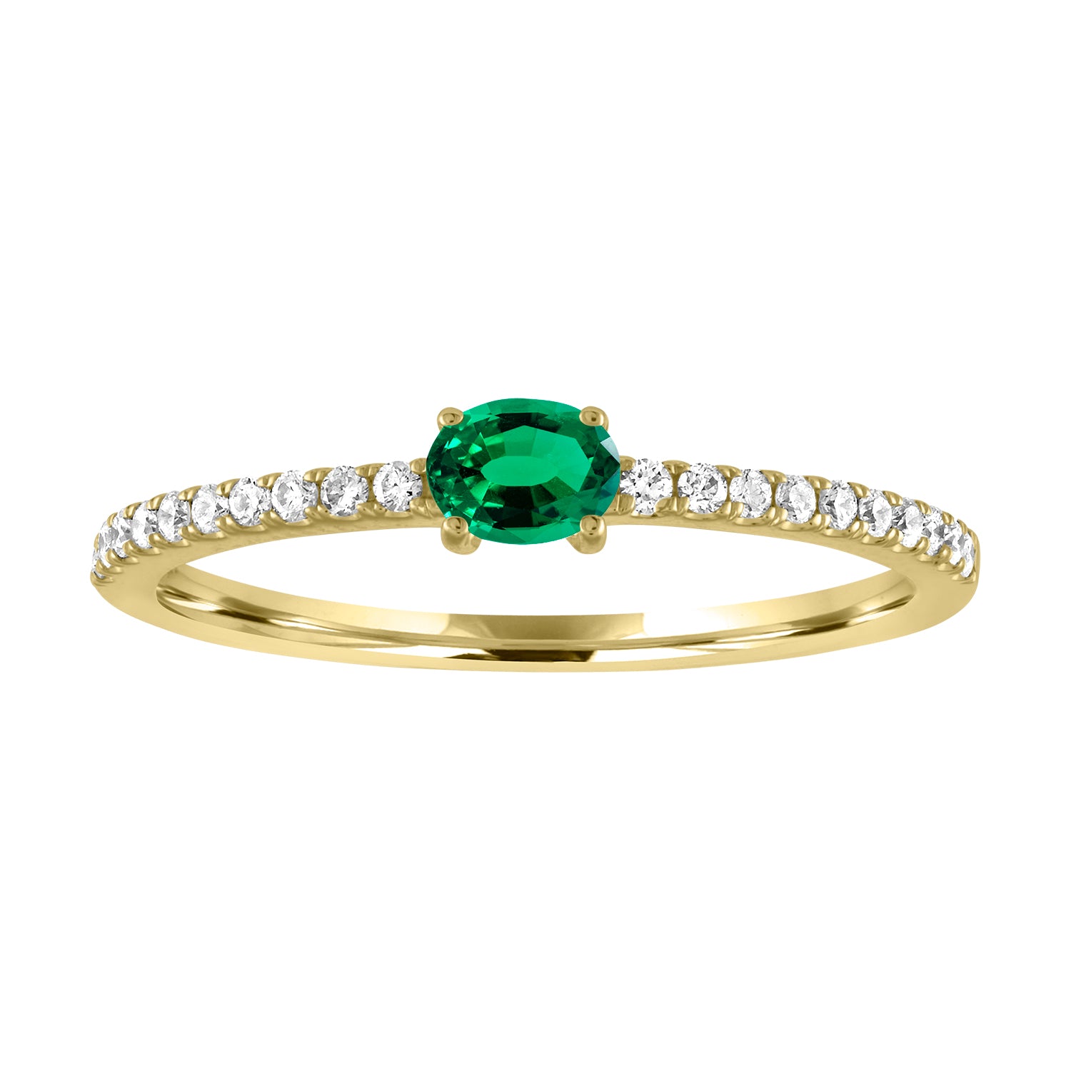 Yellow gold skinny band with an oval emerald in the center and round diamonds along the shank.