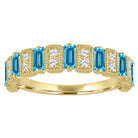 Yellow gold wide band with blue topaz baguettes and round diamonds.
