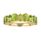 Yellow gold wide band with alternating pear shaped peridots. 