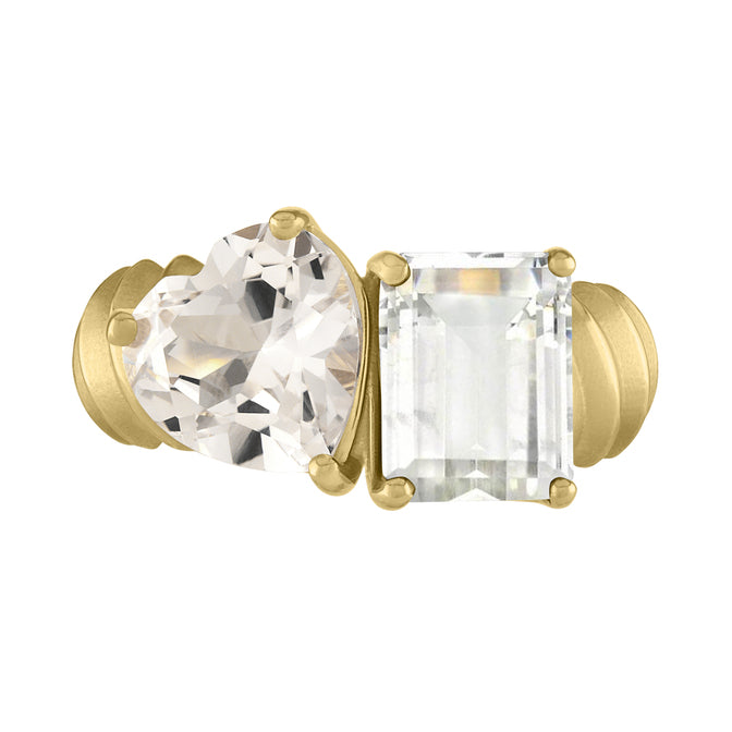 Yellow gold two-stone ring with a white sapphire emerald cut and a white topaz heart. 